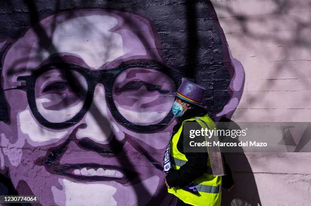 Woman passing by a feminist mural named 'Union makes force', during a protest against the removal of the mural proposed by far-right party VOX. In...