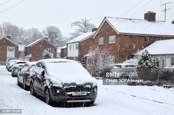 Cars covered with snow blocks seen on roads pavements during the snowfall. With severe weather warnings issued across the UK including the south and...