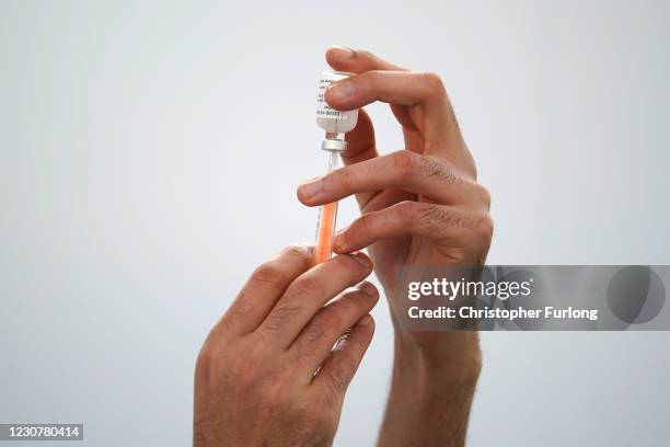 Principal Pharmacist, Syed Anas Gilani prepares to administer a Covid-19 vaccine to Principal Pharmacist, Davinder Manku who will be the first person...