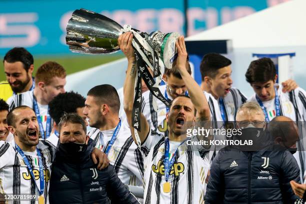 Juventus's Italian defender Leonardo Bonucci holds the trophy during the ceremony oft he Italian PS5 Supercup football match SSC Napoli vs Juventus...