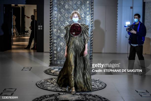 Model presents a creation by Christian Dior during a fitting session at Christian Dior's Haute Couture fashion house in Paris on January 20, 2021. -...