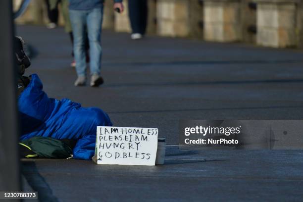 Homeless person begging on a street in Dun Laoghaire during Level 5 Covid-19 lockdown. On Monday, 25 January in Dublin, Ireland.