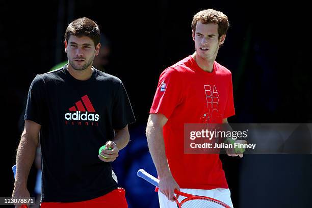 Andy Murray of Great Britain practices with Daniel Vallverdu of Venezuela during Day Two of the 2011 US Open at the USTA Billie Jean King National...