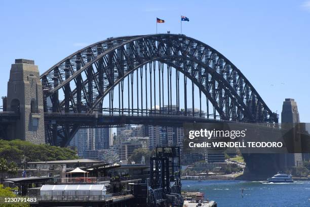 The Australian and Aboriginal flags fly on Sydney Harbour Bridge as part of Australia Day celebrations in Sydney on January 26, 2021.