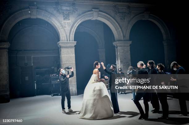 Model presenting a creation by French designer Stephane Rolland gets ready during the shooting of a film designed to replace Haute Couture fashion...