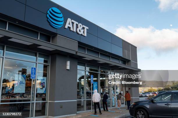 People wait to enter an AT&T store in Daly City, California, U.S., on Monday, Jan. 25, 2021. AT&T Inc. Is expected to release earnings figures on...