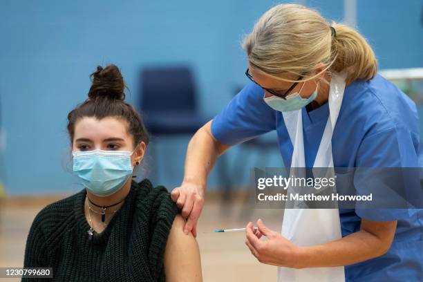 Woman receives the Pfizer-BioNTech vaccine at Cwmbran Stadium on January 26, 2021 in Cwmbran, Wales. Wales is on track to vaccinate nearly three...