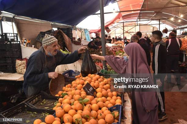 Algerians shop at the produce market in the Bab el-Oued suburb of Algeria's capital Algiers, on January 26, 2021.