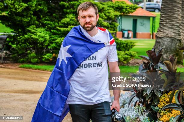 Activist is seen wrapped in the Australian flag with "Slack Dan Andrews" T-shirt during the Australia Day celebrations. Members of far right...