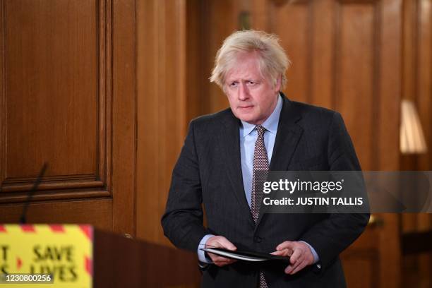 Britain's Prime Minister Boris Johnson arrives to lead a virtual press conference on the Covid-19 pandemic, inside 10 Downing Street in central...