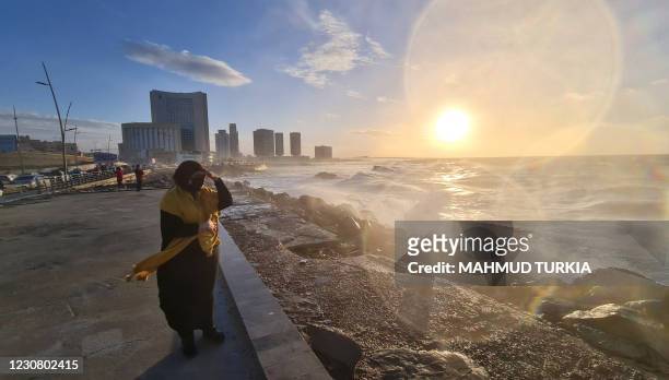 Libyan woman stands on the shore of the Mediterranean Sea in the capital Tripoli on January 26, 2021.