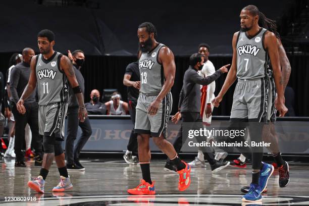 Kyrie Irving, James Harden and and Kevin Durant of the Brooklyn Nets walk off the court during the game against the Miami Heat on January 25, 2021 at...