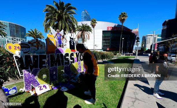 Fan bows toward a makeshift memorial near Staples Center in Los Angeles, California on January 26 marking the one-year death anniversary of former...