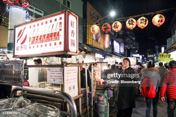 Pedestrians walk past stalls at the Linjiang night market in Taipei, Taiwan, on Tuesday, Jan. 26, 2021. Taiwan is scheduled to release gross domestic...