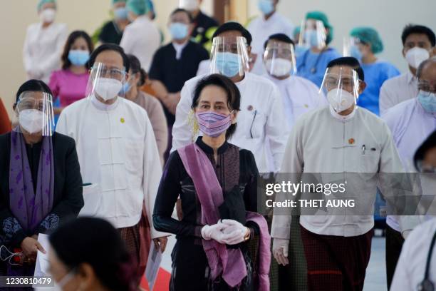 Myanmar's State Counsellor Aung San Suu Kyi looks on as health workers receive a vaccine for the Covid-19 coronavirus at a hospital in Naypyidaw on...