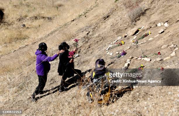 Jan. 26, 2021 -- People place flowers in honor of of late basketball legend Kobe Bryant at the site of a helicopter crash that killed Kobe Bryant,...