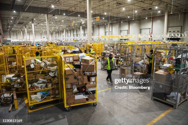 Worker passes parcel cages at the InPost SA sorting facility in Bronisze, Poland, on Wednesday, Jan. 27, 2021. InPost soared in Amsterdam trading...