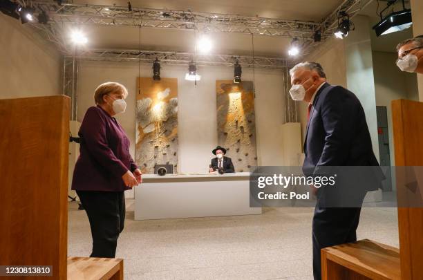 German Chancellor Angela Merkel and Israel's Ambassador to Germany Jeremy Issacharoff watch as the historic Sulzbach Torah Scroll from 1792,...