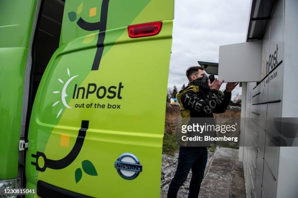 Worker delivers a parcel to an InPost SA postal locker in Warsaw, Poland, on Wednesday, Jan. 27, 2021. InPost soared in Amsterdam trading after its...