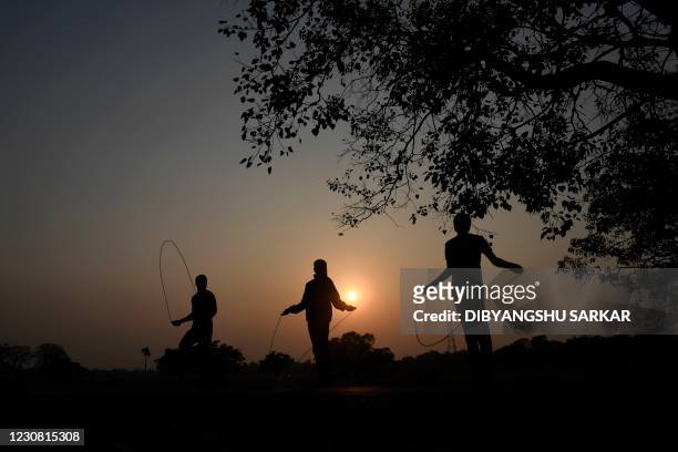 Youths exercise at the Maidan area in Kolkata on January 27, 2021.