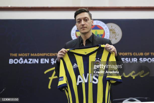 New transfer of Fenerbahce, Mesut Ozil poses for a photo with his new jersey during signing ceremony after he was transferred from Arsenal at Faruk...