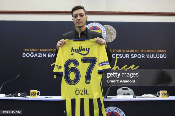 New transfer of Fenerbahce, Mesut Ozil poses for a photo with his new jersey during signing ceremony after he was transferred from Arsenal at Faruk...