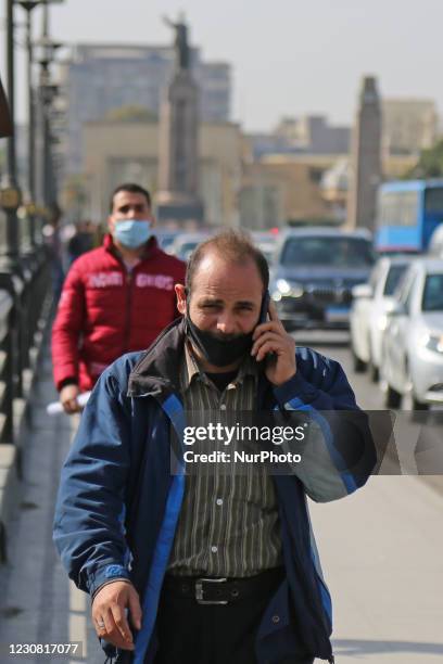 Face masks have become mandatory in public places in Egypt. Egyptians wear masks to prevent COVID-19, Qasr al-Nil Bridge, Cairo, Egypt, January 27,...