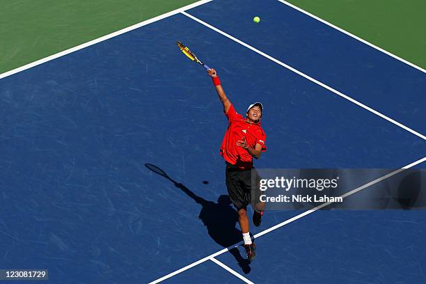 Yen-Hsun Lu of Taiwan returns a shot against Jo-Wilfried Tsonga of France during Day Two of the 2011 US Open at the USTA Billie Jean King National...