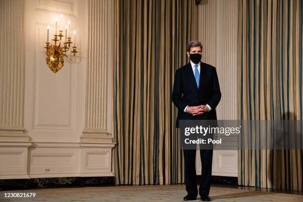 Special Presidential Envoy for Climate John Kerry listens as U.S. President Joe Biden speaks about climate change issues in the State Dining Room of...