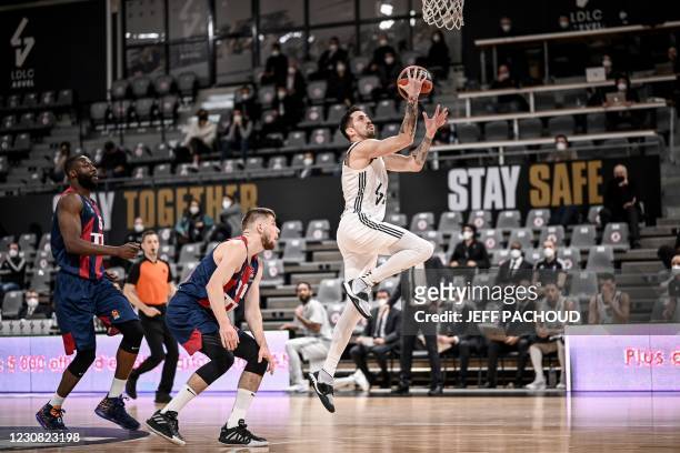 Lyon-Villeurbanne's French player Paul Lacombe scores during the Euroleague basket ball match between ASVEL Lyon-Villeurbanne and TD Systems Baskonia...