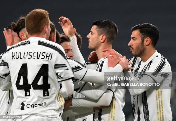 Juventus' Spanish forward Alvaro Morata celebrates with teammates after scoring a penalty during the Italian Cup quarter final football match between...