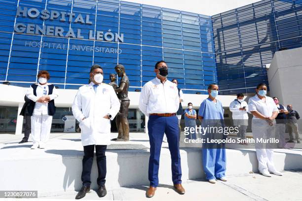 Doctor Ruben Ramirez Sub Director of Hospital General de Leon afternoon shift, and Bernardo Rodriguez Contreras union leader stand during a ceremony...