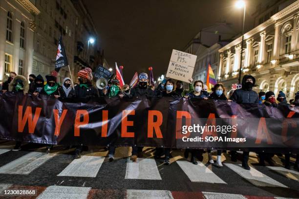 Protesters march through the Streets while holding a banner during the demonstration. Hundreds took the streets in Warsaw to take part in a protest...