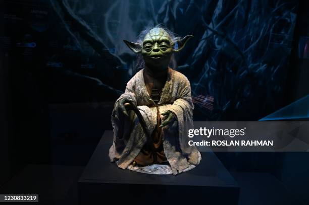 Life-size figurine of Yoda from the Star Wars series is displayed at the Star Wars Identities exhibition during a media preview at the ArtScience...