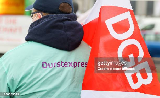January 2021, Saxony, Leipzig: Employees of the drinks delivery service durstexpress.de protest in front of a Flaschenpost warehouse against the...