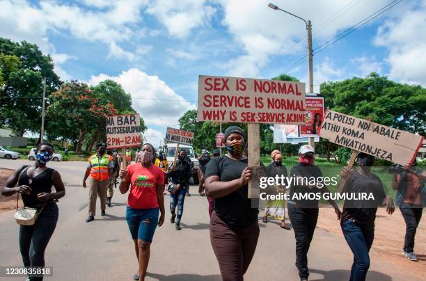 Members of the Female Sex Workers Association in Malawi participate in a march in Lilongwe, on January 28 to demonstrate against governments COVID-19...