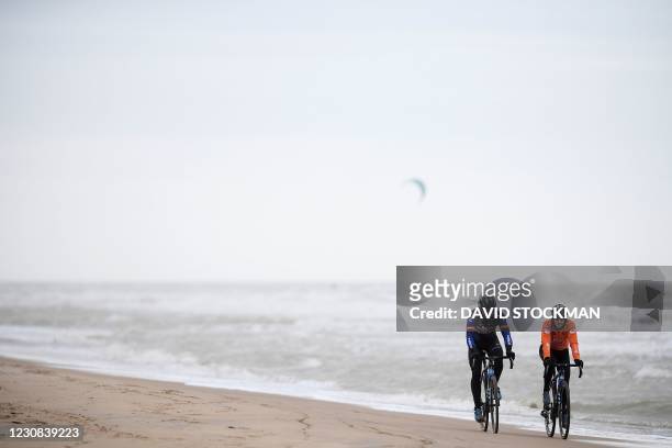 Belgian former cyclocross champion Sven Nys and Dutch Lucinda Brand ride on a beach during a track reconnaissance and training session ahead of the...