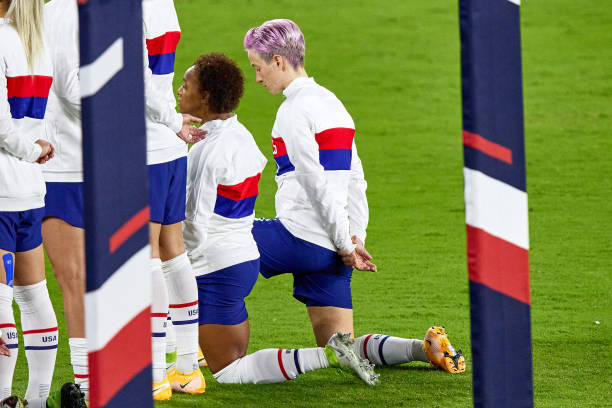 Several United States players including United States forward Megan Rapinoe and United States defender Crystal Dunn are seen taking a kneel during...
