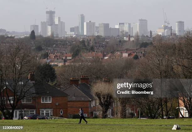 Man exercises in a park overlooking the city center of Birmingham, U.K., on Thursday, Jan. 28, 2021. U.K. Government officials have suggested paying...