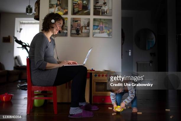 Bonn, Germany In this photo illustration a pregnant woman is working in home-office on January 28, 2021 in Bonn, Germany.