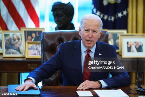 President Joe Biden speaks before signing executive orders on health care, in the Oval Office of the White House in Washington, DC, on January 28,...