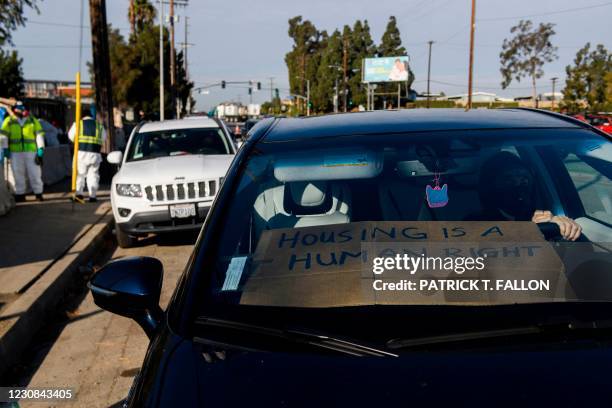 Activists with Services Not Sweeps hold a car blockade to prevent the removal of tent shelters before Los Angeles City Bureau of Sanitation performs...