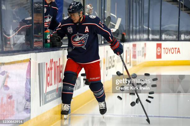 Cam Atkinson of the Columbus Blue Jackets knocks down the stack of warmup pucks prior to the start of the game against the Florida Panthers at...