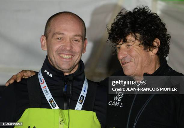 Kevin Escoffier joins French skipper Jean Le Cam who is celebrating after crossing the finish line of the Vendee Globe round-the-world solo sailing...