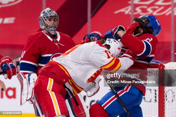 Ben Chiarot of the Montreal Canadiens and Matthew Tkachuk of the Calgary Flames play rough during the third period at the Bell Centre on January 28,...