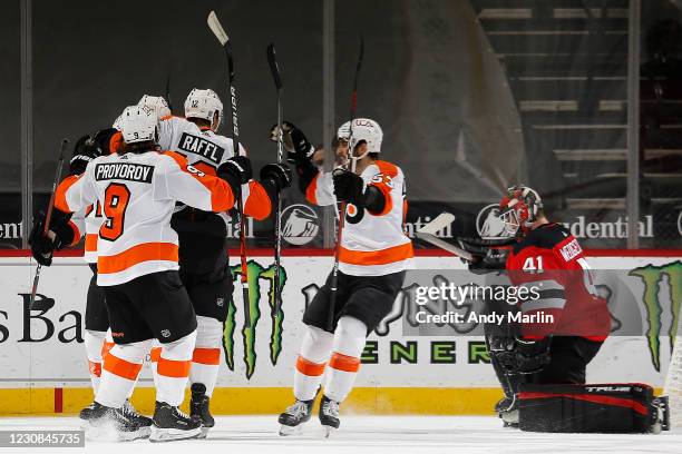 Michael Raffl of the Philadelphia Flyers is congratulated by his teammates after scoring a goal past Scott Wedgewood of the New Jersey Devils during...