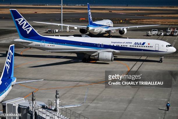 An All Nippon Airways Boeing 767 passenger aircraft taxis on the tarmac at Tokyo's Haneda airport on January 29 ahead of the airline's third quarter...