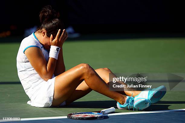Jamie Hampton of the United States reacts after an injury against Elena Baltacha of Great Britain during Day Two of the 2011 US Open at the USTA...