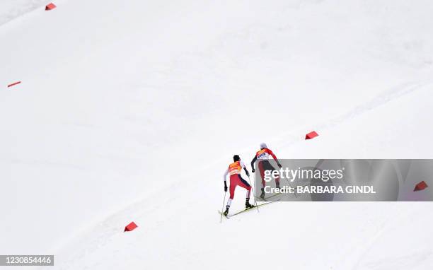 Norway's Jarl Magnus Riiber competes to win ahead of Japan's Akito Watabe during the Men's Gundersen Normal Hill 5km event of the FIS Nordic Combined...