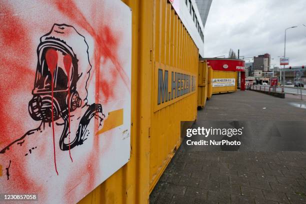 Sign of a man with chemical protection mask as seen vandalized with graffiti on the containers. The Philips Stadion, PSV club stadium in the Dutch...